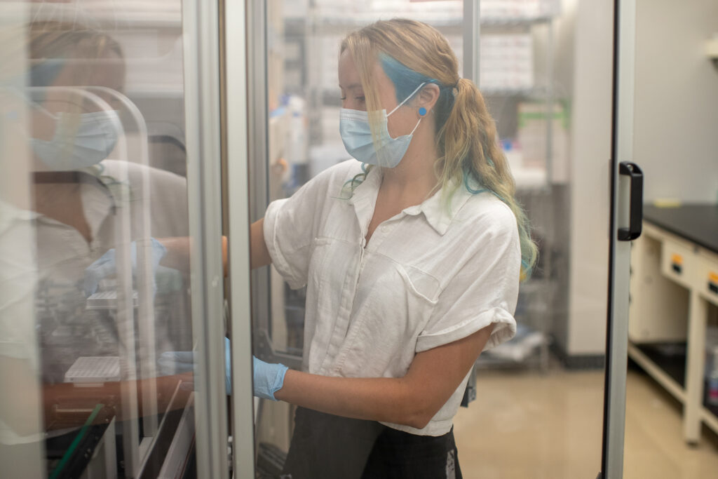 Hannah Dose loads samples in the LJI Next Generation Sequencing Core.