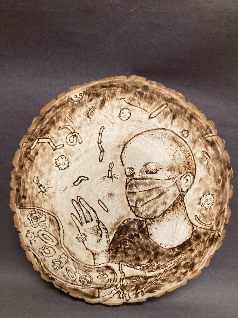 A circle of wood from a section of tree stump. Brown lines show a person with a surgical mask on. They have a hand outstretched to ward away the surrounding pathogens.