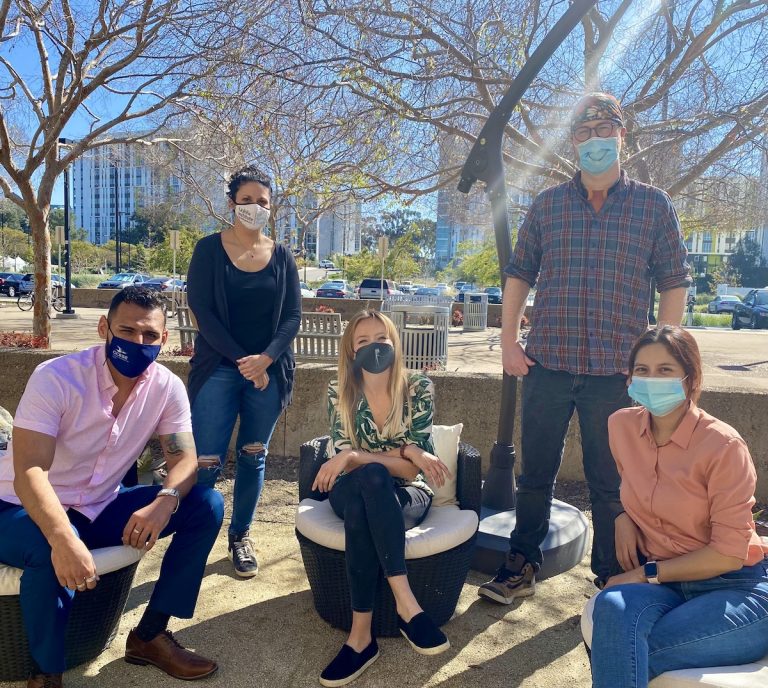 Photo of five Next Gen Sequencing employees standing outside the LJI building