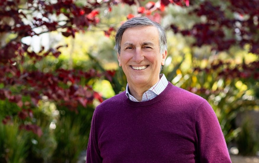 Portrait photo of Dr. Alessandro Sette. He stands outside and smiles at the camera