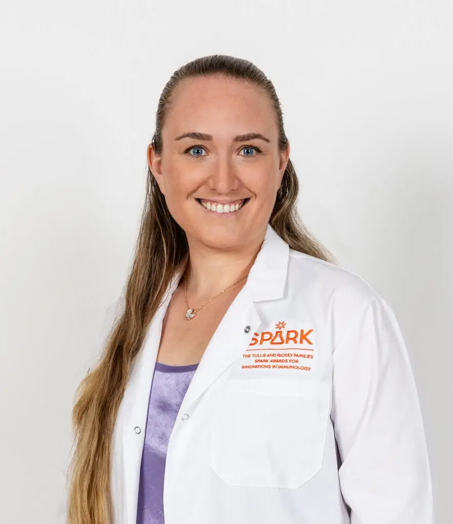 Portrait photo of Kelly Shaffer. She is wearing a white lab coat and smiling at the camera